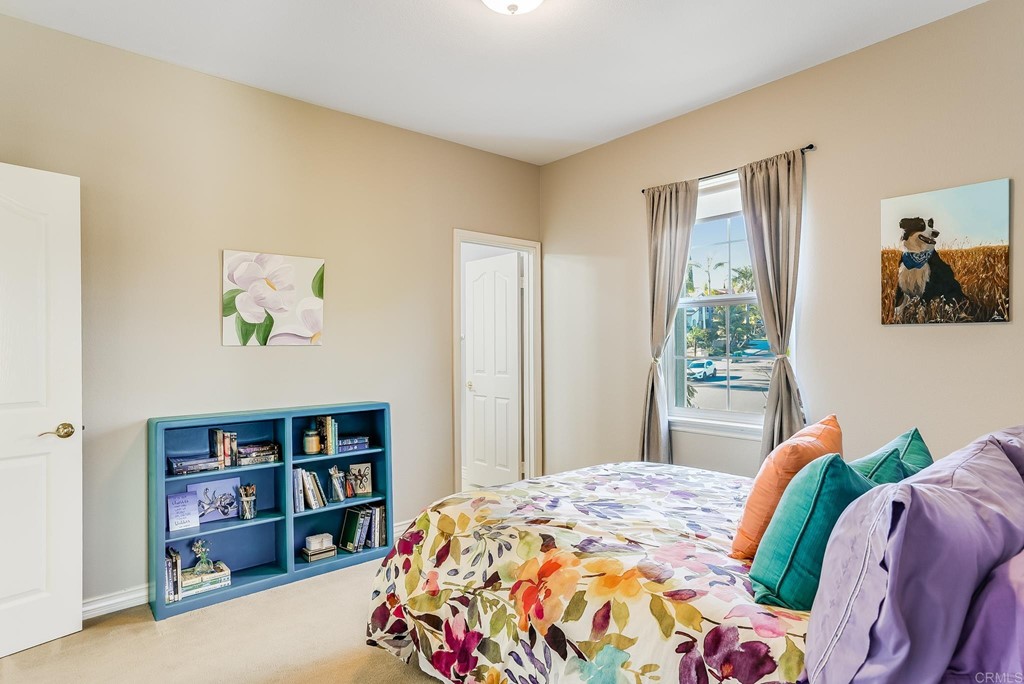 8046 Calle Pinon Carlsbad, CA 92009 - Photo 39 of 51 a bedroom with a bed and a book shelf