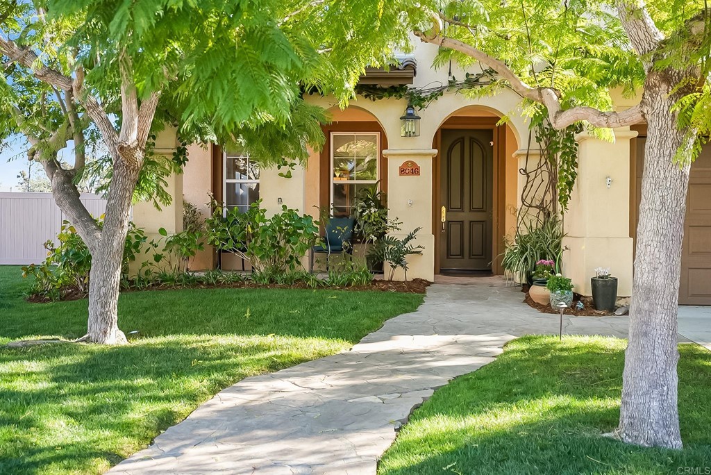 8046 Calle Pinon Carlsbad, CA 92009 - Photo 4 of 51 a front view of a house with garden