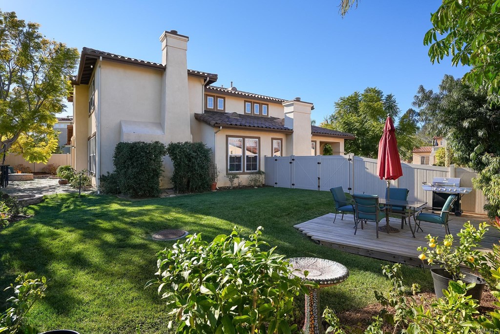 8046 Calle Pinon Carlsbad, CA 92009 - Photo 47 of 51 a house view with a seating space and garden