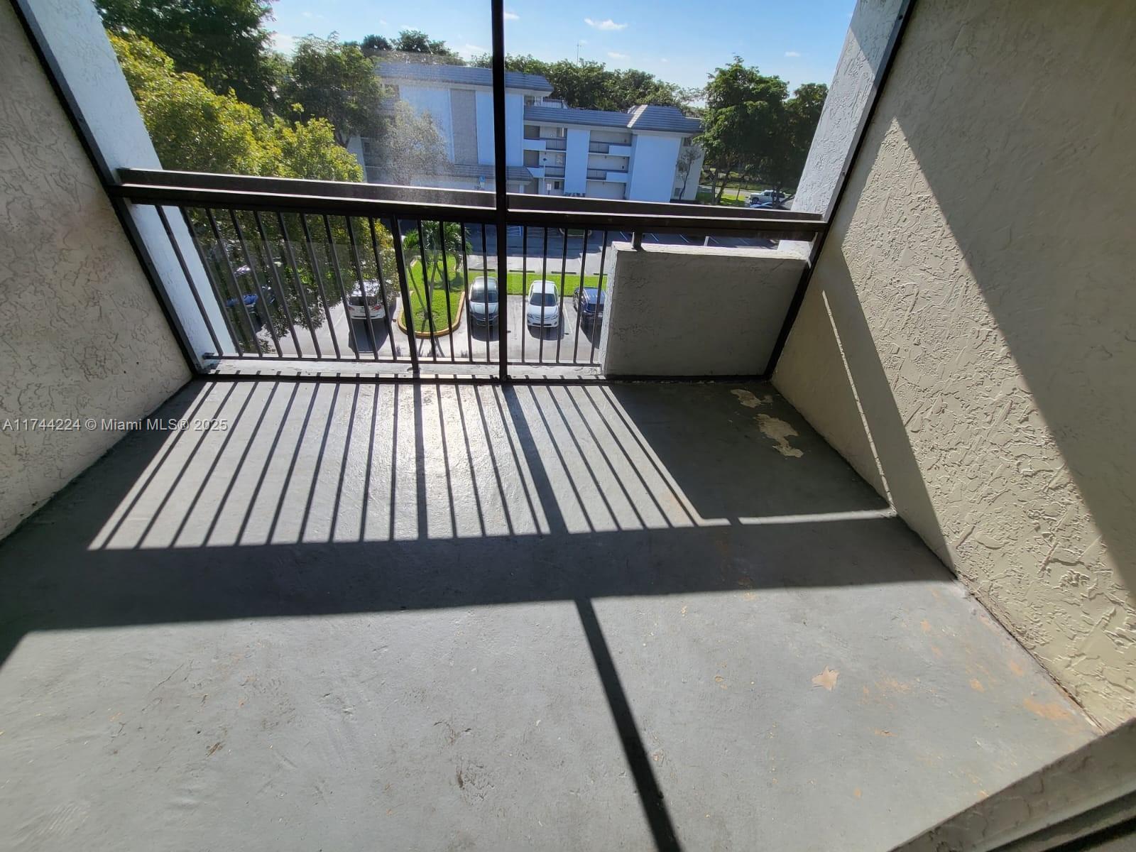 711 North Pine Island Road, Unit 407 Plantation, FL 33324 - Photo 11 of 11 a view of balcony with wooden floor and fence