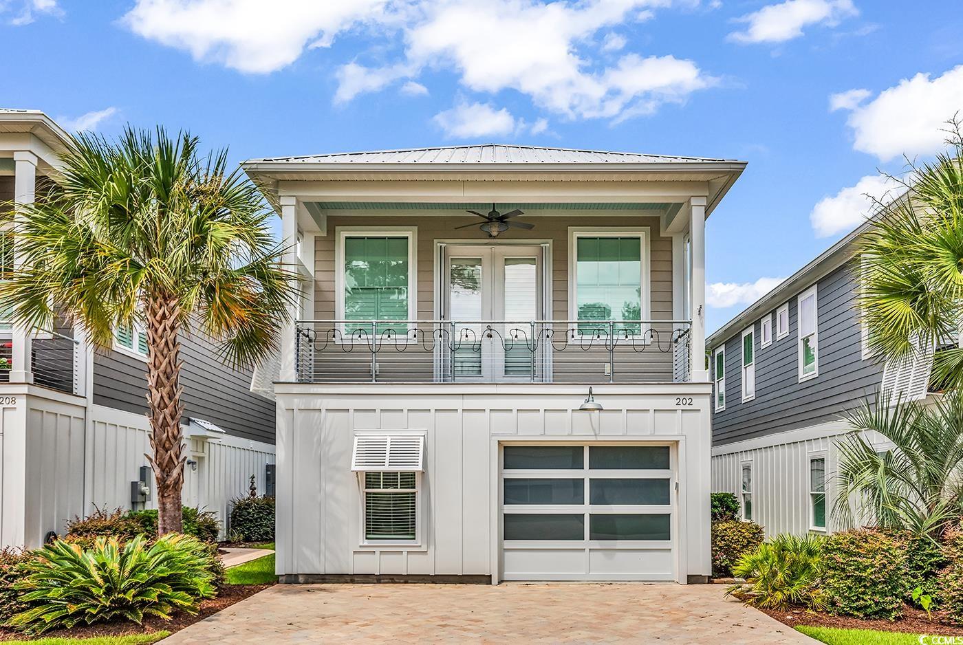 202 Clam Digger Loop Pawleys Island, SC 29585 - Photo 1 of 28 View of front facade with ceiling fan, board and b