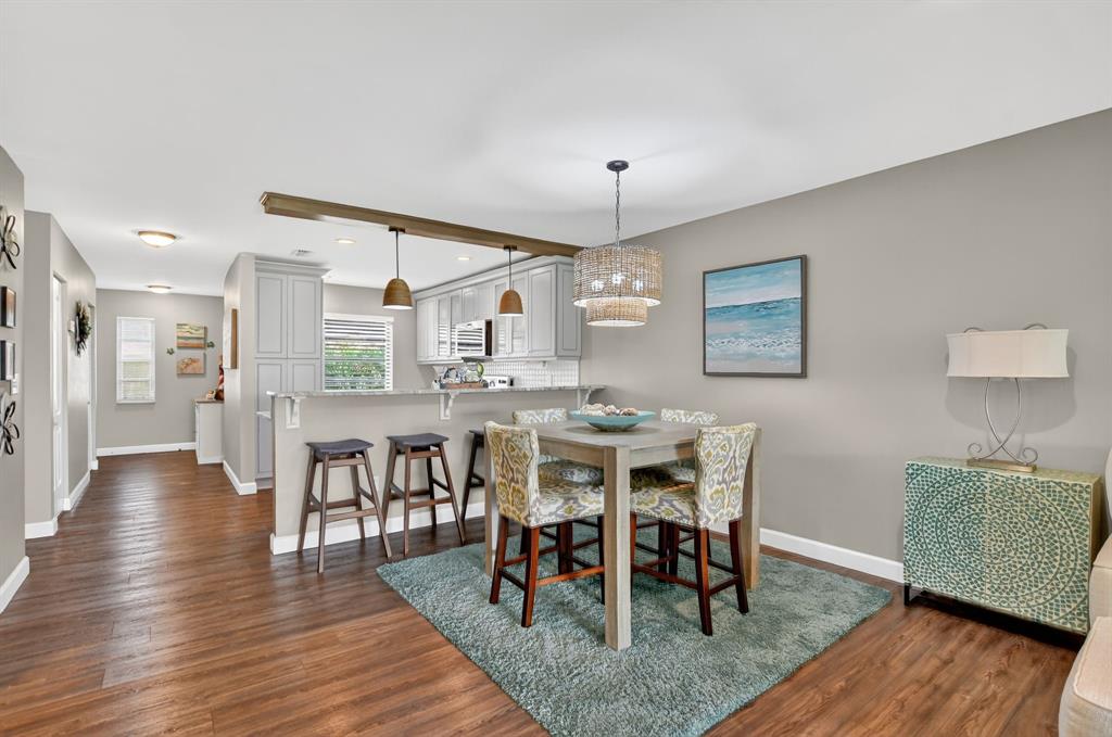 21219 Lago Circle, Unit J5 Boca Raton, FL 33433 - Photo 15 of 46 a view of a dining room with furniture and wooden floor