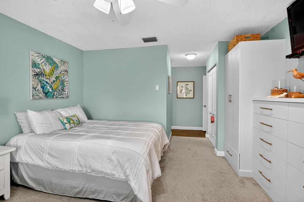 21219 Lago Circle, Unit J5 Boca Raton, FL 33433 - Photo 22 of 46 a bedroom with a bed and a chandelier