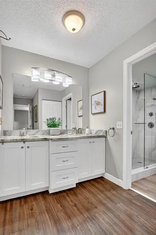 a bathroom with a double vanity sink and a mirror