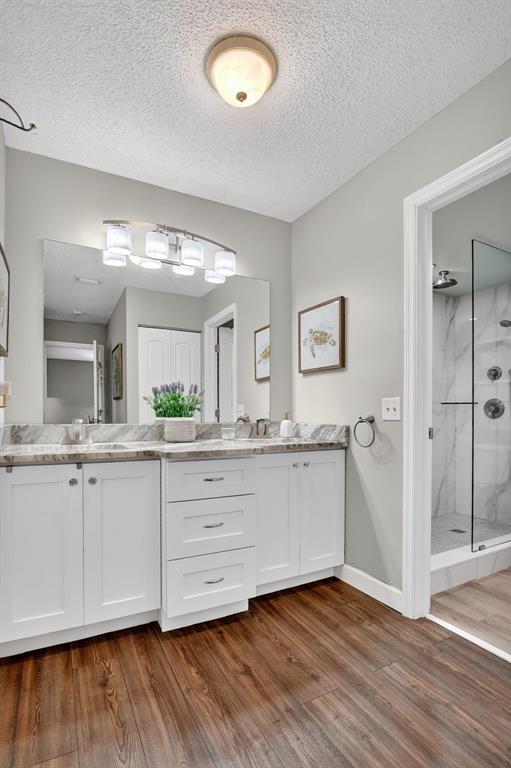 21219 Lago Circle, Unit J5 Boca Raton, FL 33433 - Photo 25 of 46 a bathroom with a double vanity sink and a mirror