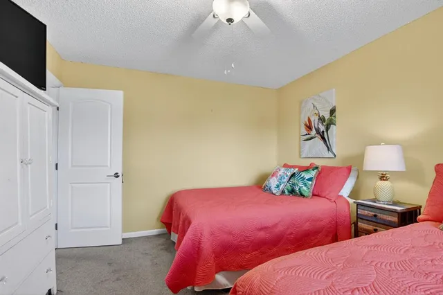 a bedroom with two bed and a flat screen tv