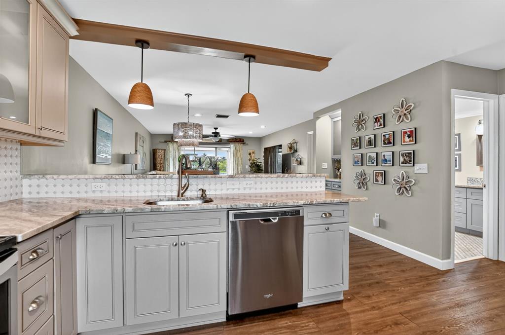 21219 Lago Circle, Unit J5 Boca Raton, FL 33433 - Photo 3 of 46 a kitchen with a sink and wooden floor