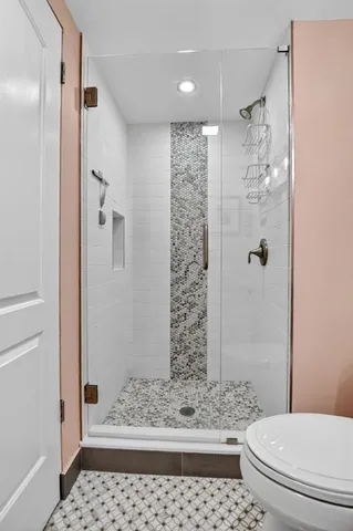 a bathroom with a toilet and shower