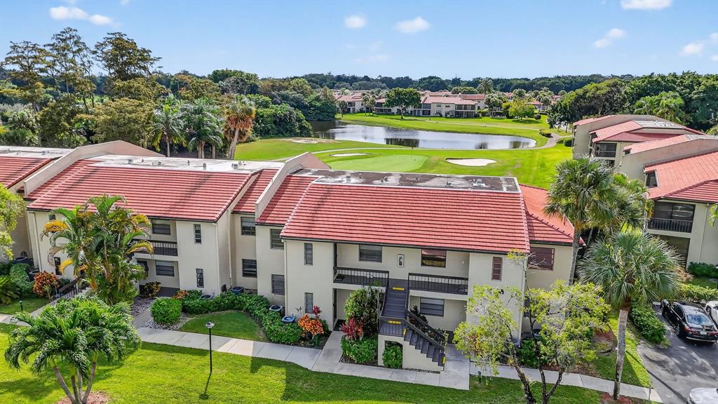 21219 Lago Circle, Unit J5 Boca Raton, FL 33433 - Photo 37 of 46 a view of a house with pool and a yard