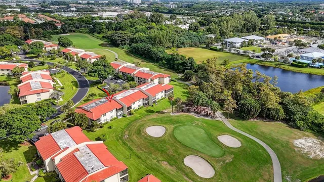 an aerial view of a swimming pool patio and lake view