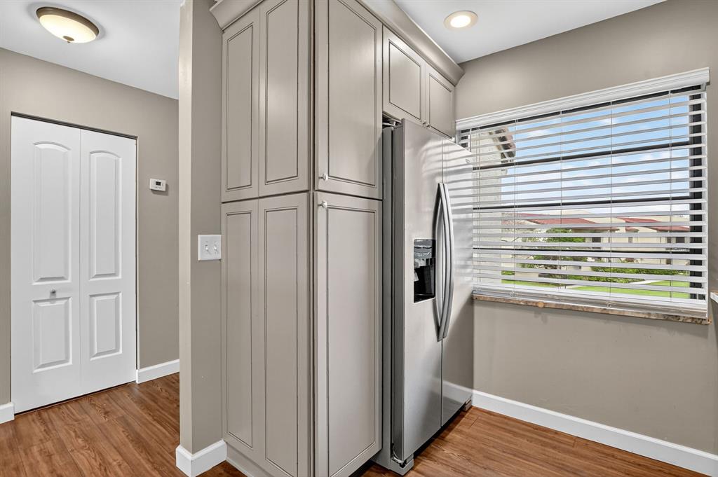21219 Lago Circle, Unit J5 Boca Raton, FL 33433 - Photo 5 of 46 a view of a refrigerator and wooden floor