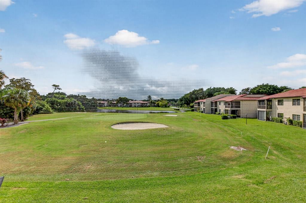 21219 Lago Circle, Unit J5 Boca Raton, FL 33433 - Photo 6 of 46 a view of a house with a big yard