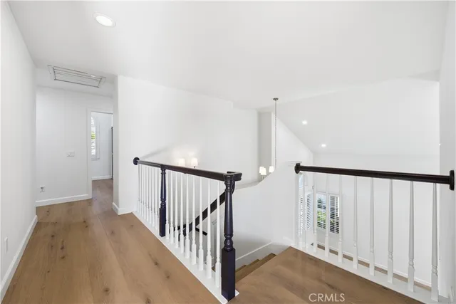 a view of a hallway with wooden floor