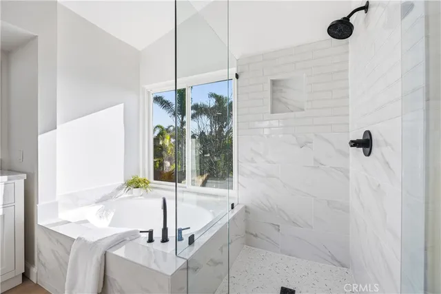 a view of a patio with table and chairs and wooden fence