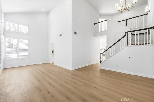 a kitchen with stainless steel appliances kitchen island granite countertop a stove a sink and white cabinets