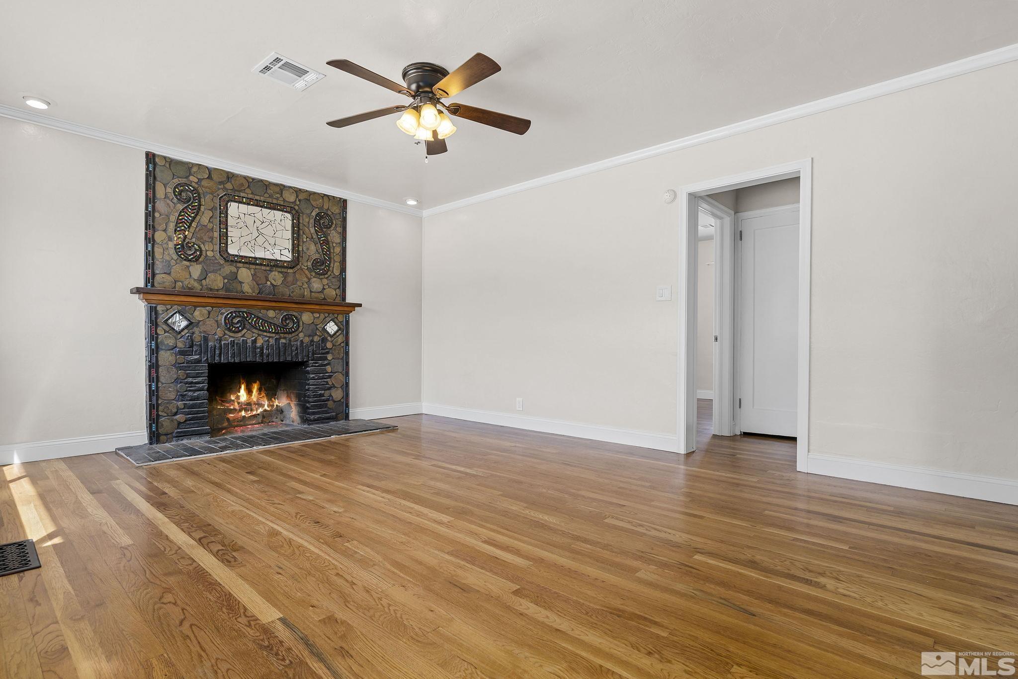 1445 University Terrace Reno, NV 89503 - Photo 3 of 17 a view of an empty room with a fireplace and a window
