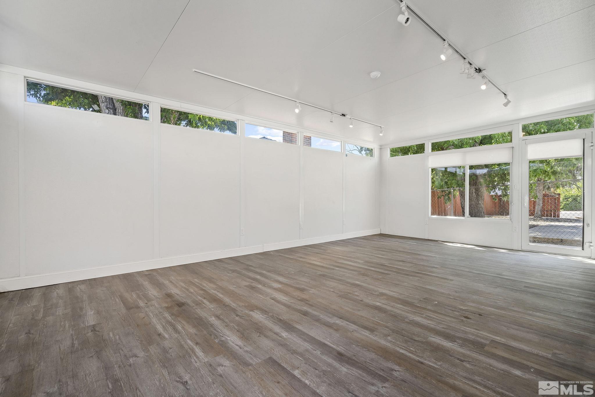 1445 University Terrace Reno, NV 89503 - Photo 9 of 17 an empty room with wooden floor and windows