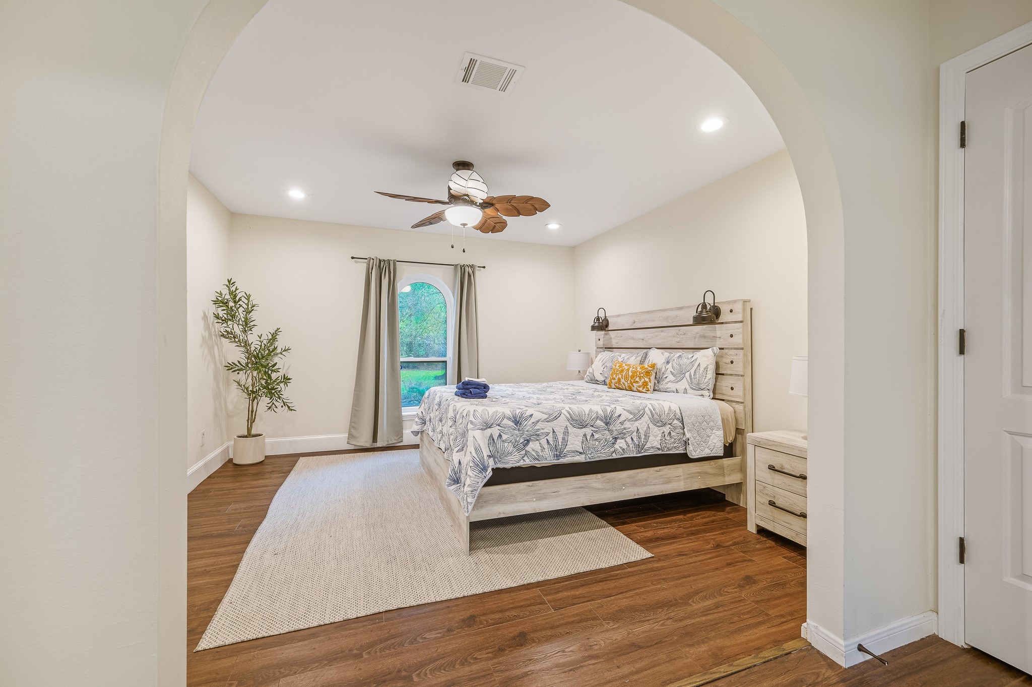 16811 Waycreek Road Houston, TX 77068 - Photo 34 of 50 a bedroom with a large bed and a chandelier