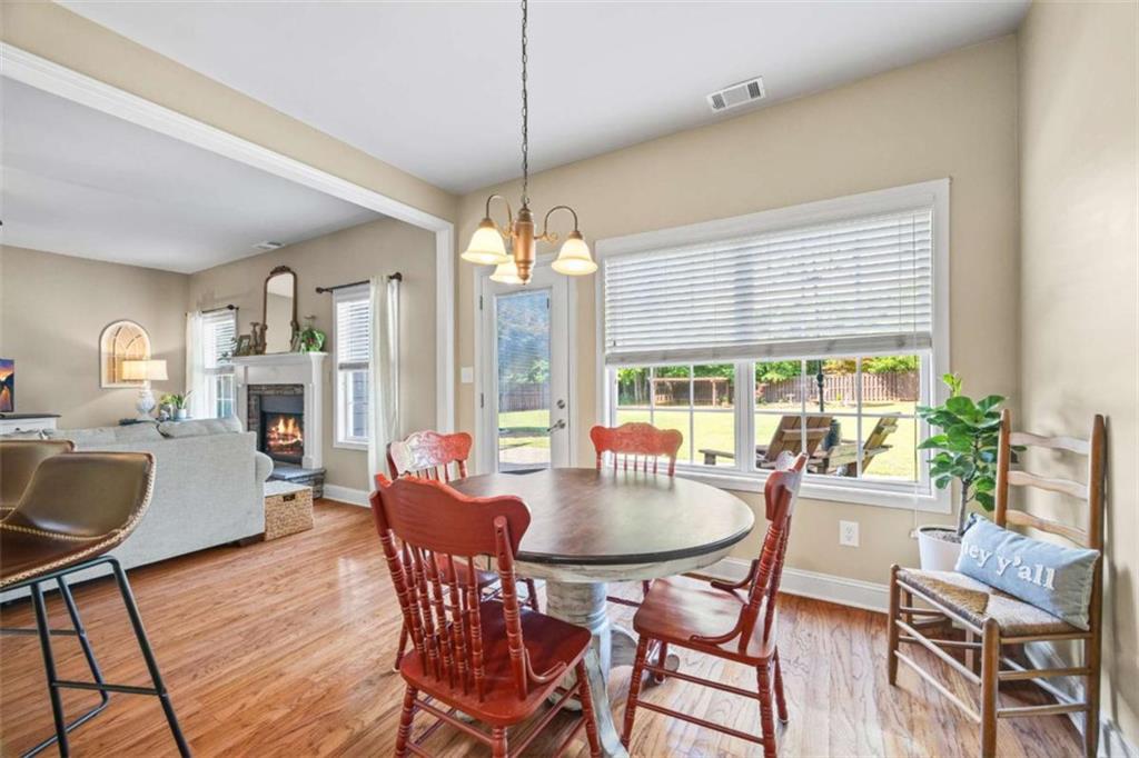 42 Pintail Lane Jefferson, GA 30549 - Photo 8 of 42 a dining room with wooden floor a chandelier a wooden table and chairs