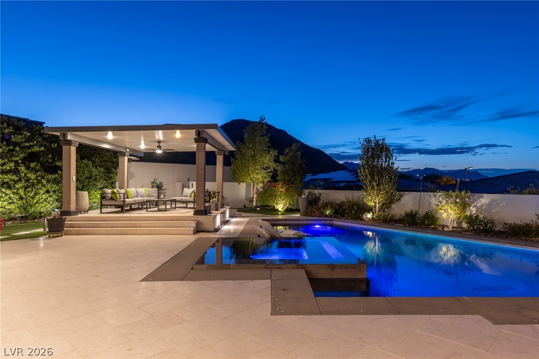 10118 Copper Edge Road Las Vegas, NV 89148 - Photo 35 of 48 An illuminated pool and covered patio create an ideal setting for twilight entertainment.