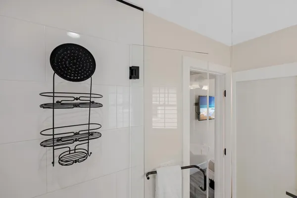 a bathroom with a sink toilet a mirror and shower