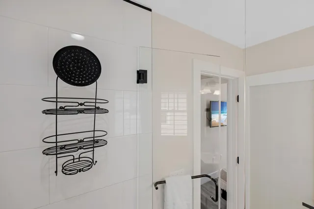 a bathroom with a sink toilet a mirror and shower