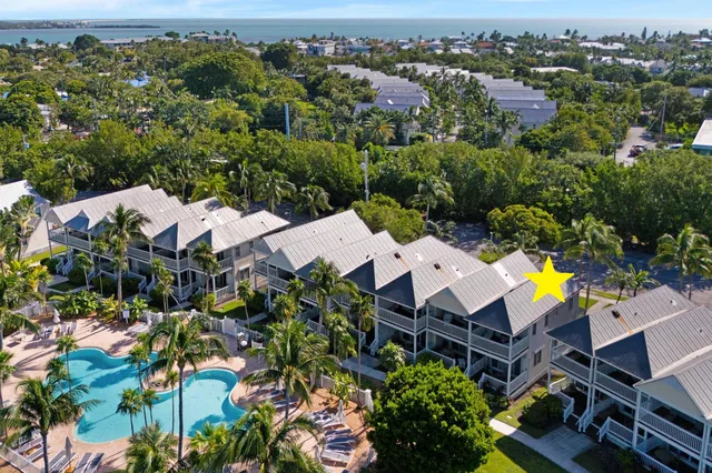 an aerial view of a houses with a lake view