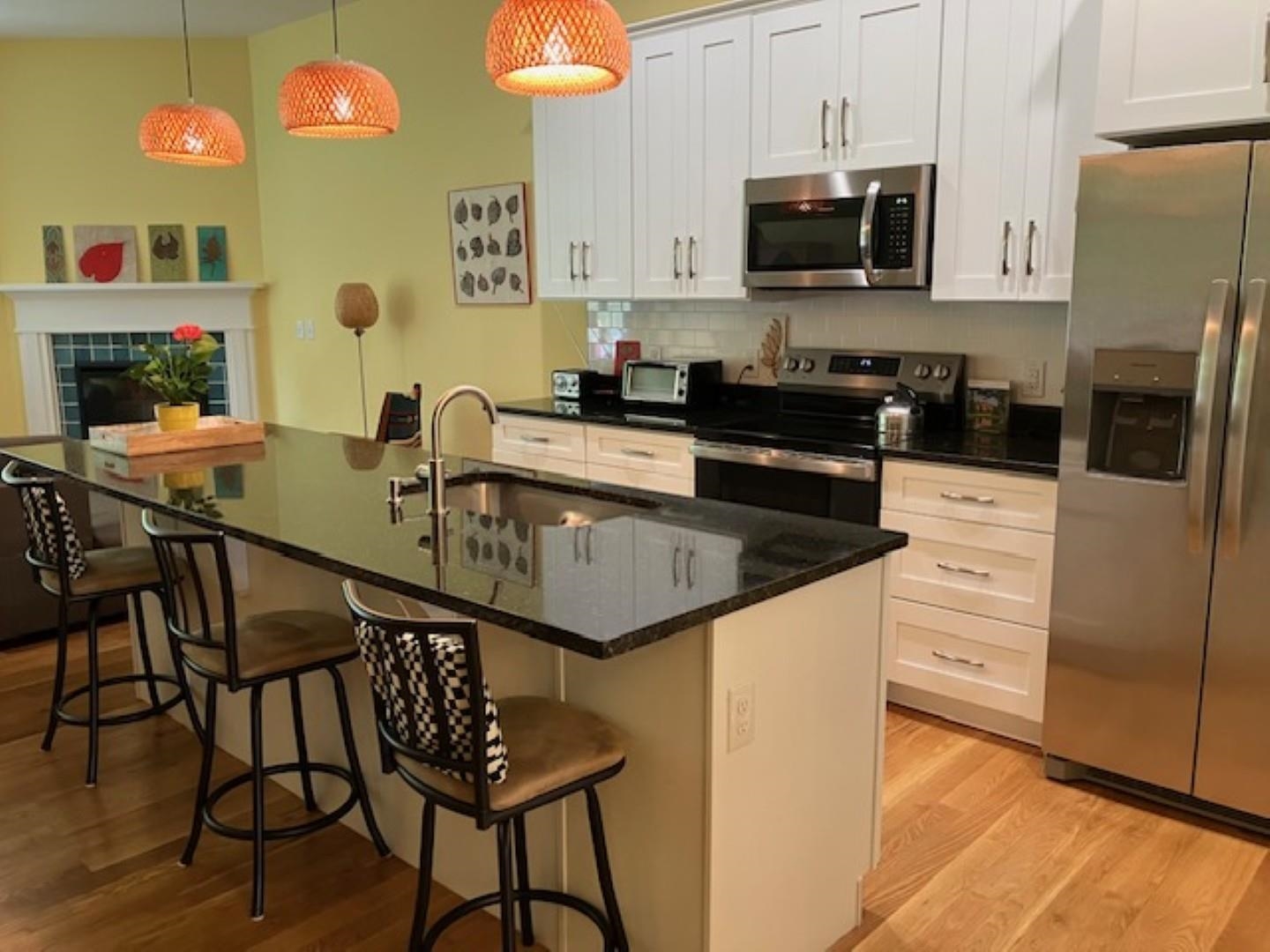 1203 Stocker Street Staunton, VA 24401 - Photo 7 of 35 a kitchen with stainless steel appliances granite countertop a sink a stove a microwave a refrigerator and cabinets
