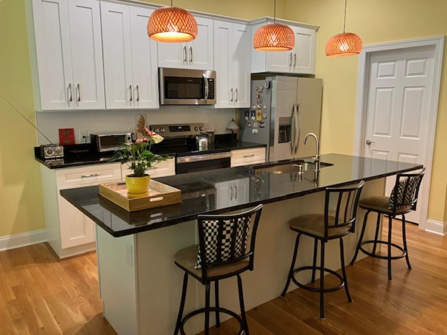 1203 Stocker Street Staunton, VA 24401 - Photo 8 of 35 a kitchen with stainless steel appliances a stove a sink and a refrigerator