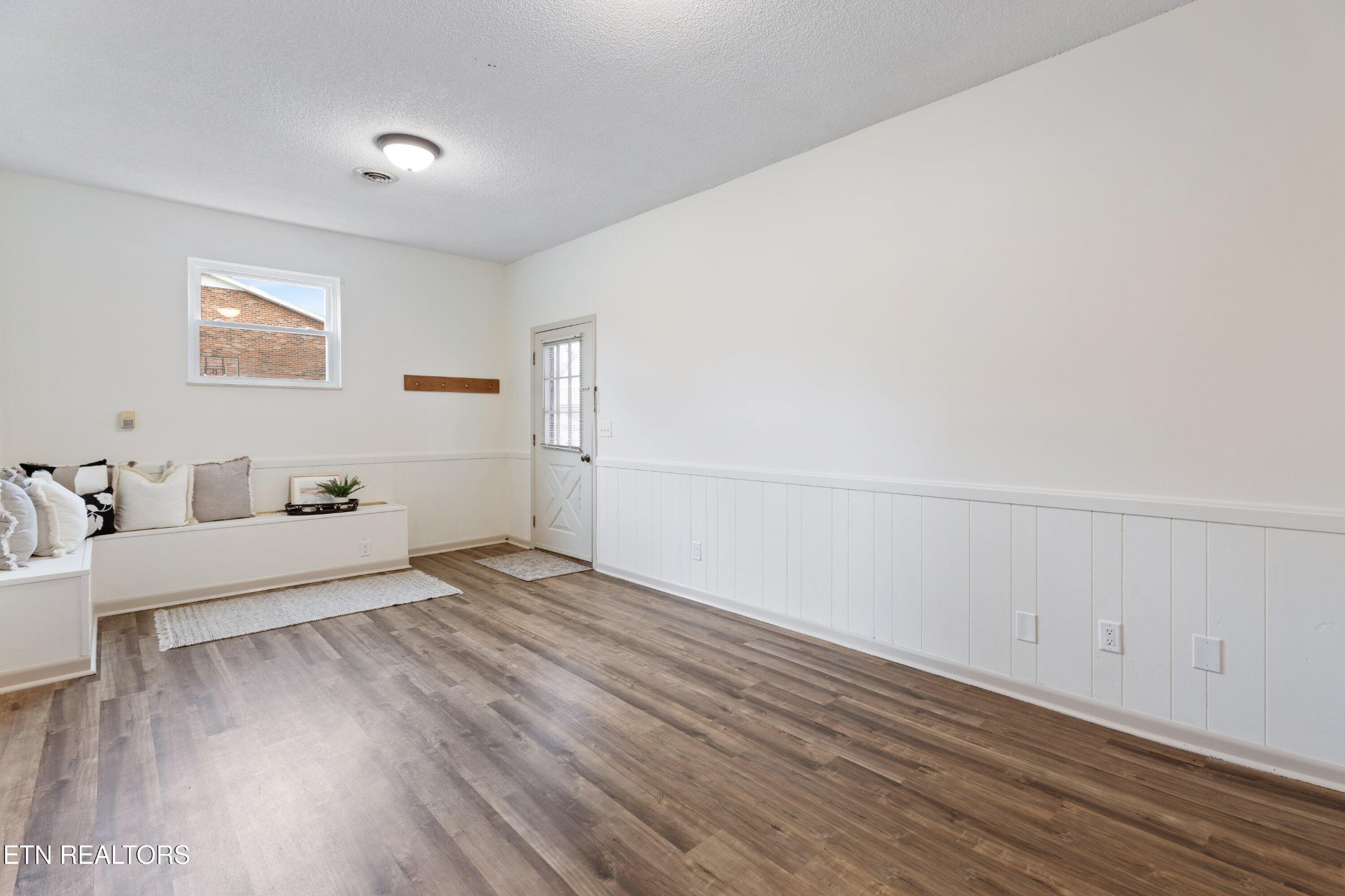 912 Naples Road Knoxville, TN 37923 - Photo 12 of 49 an empty room with wooden floor and windows