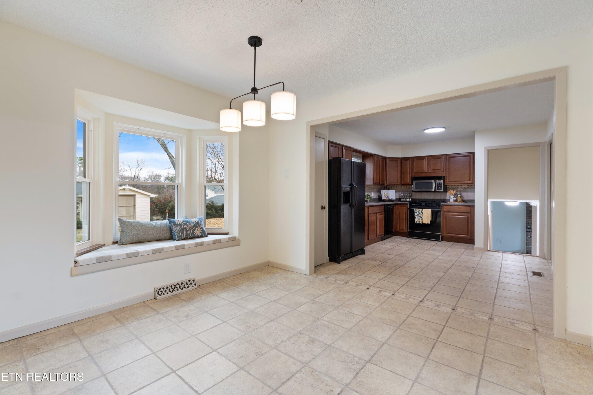 912 Naples Road Knoxville, TN 37923 - Photo 16 of 49 a view of an empty room with a kitchen
