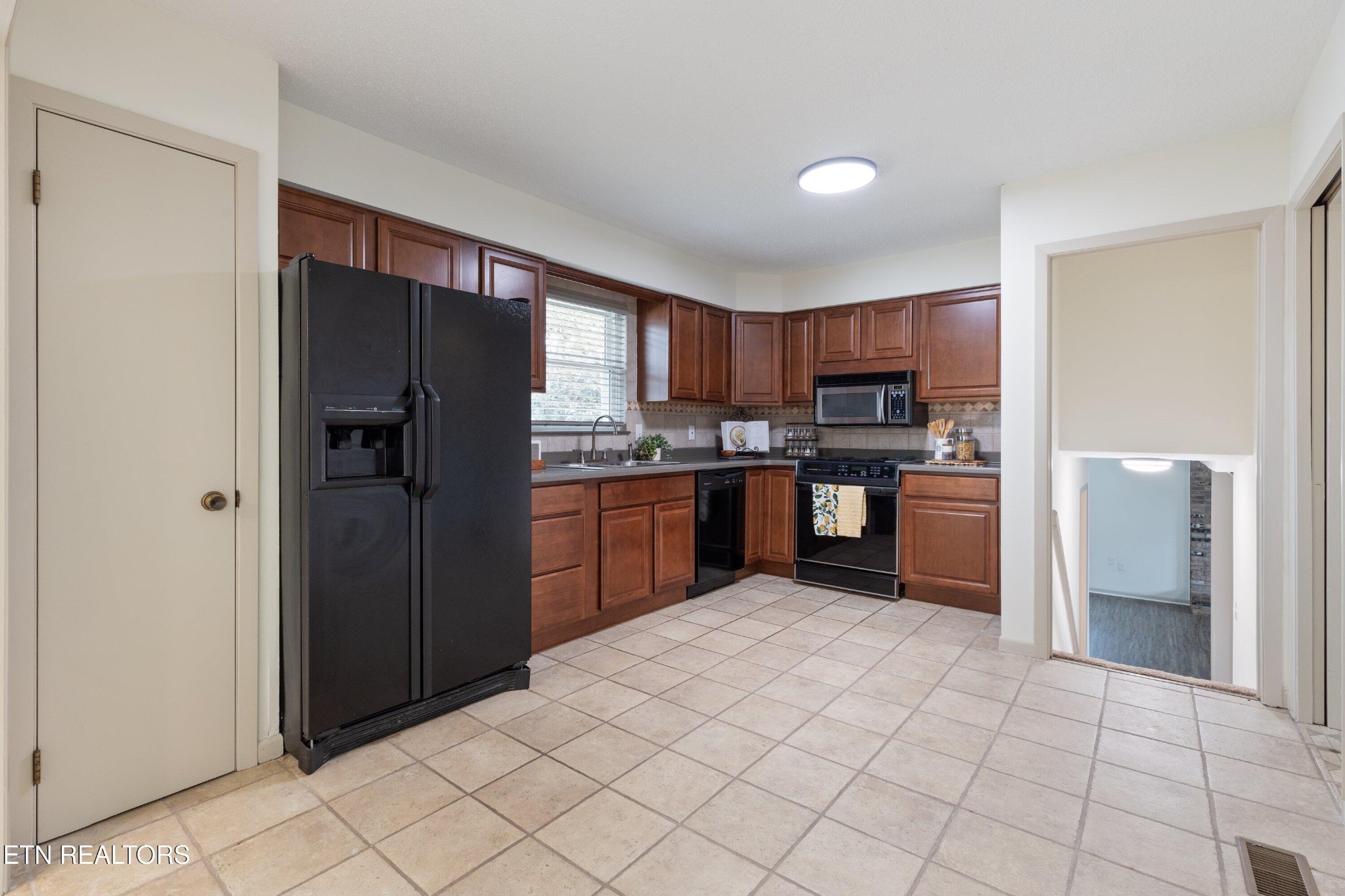 912 Naples Road Knoxville, TN 37923 - Photo 18 of 49 a kitchen with stainless steel appliances granite countertop a refrigerator and a sink