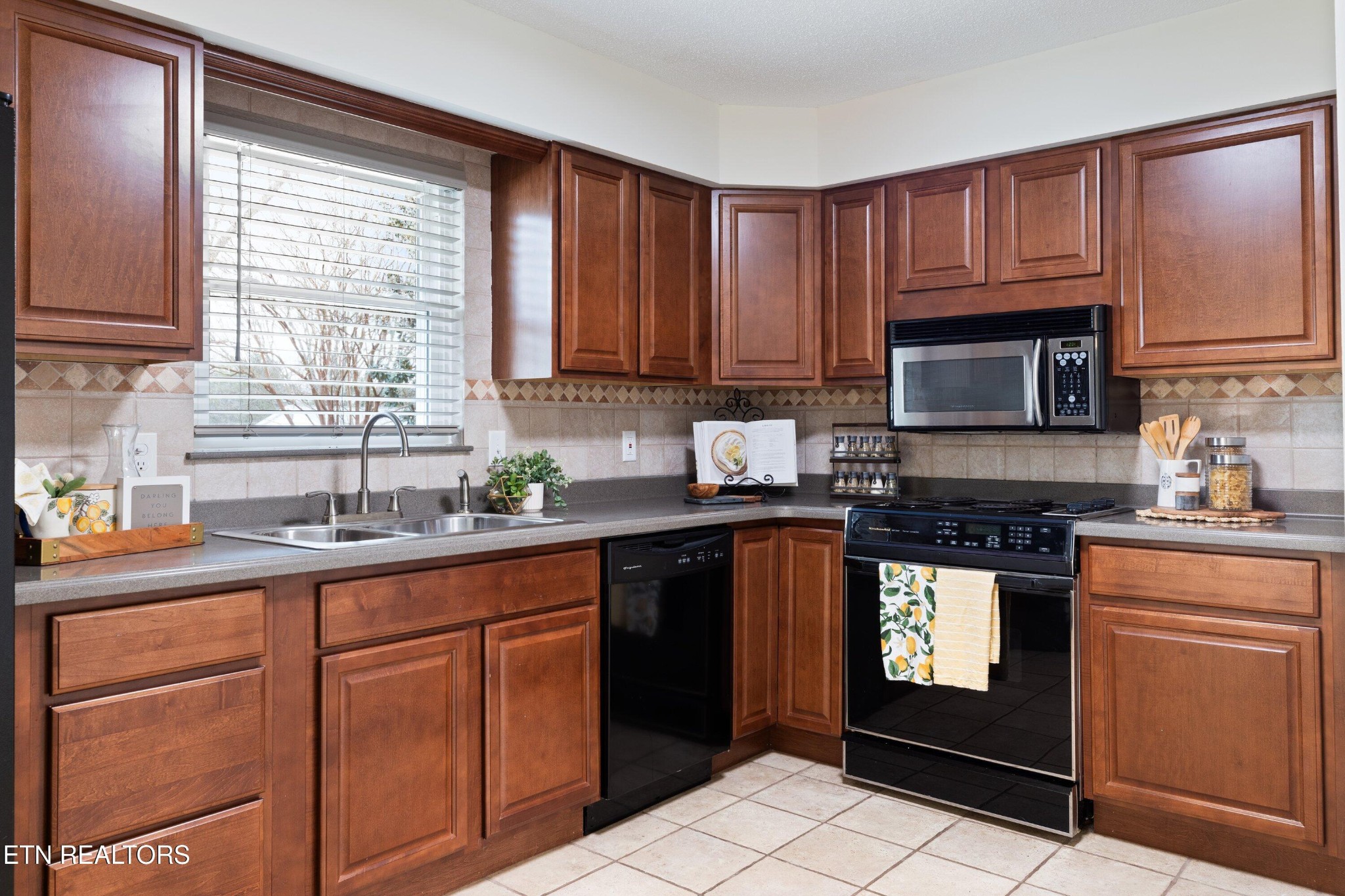 912 Naples Road Knoxville, TN 37923 - Photo 19 of 49 a kitchen with cabinets appliances a sink and a window