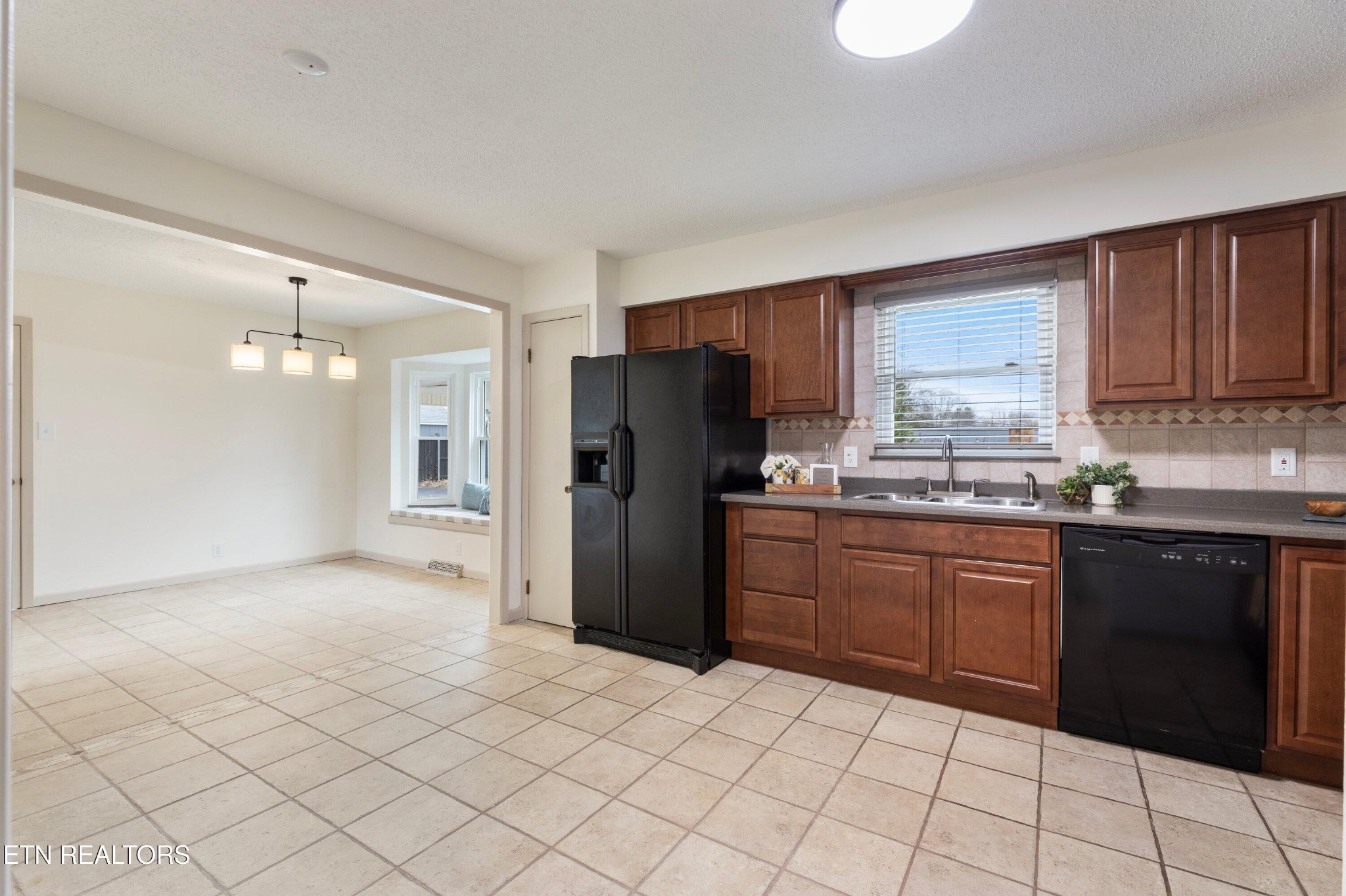 912 Naples Road Knoxville, TN 37923 - Photo 20 of 49 a kitchen with granite countertop a refrigerator and a sink