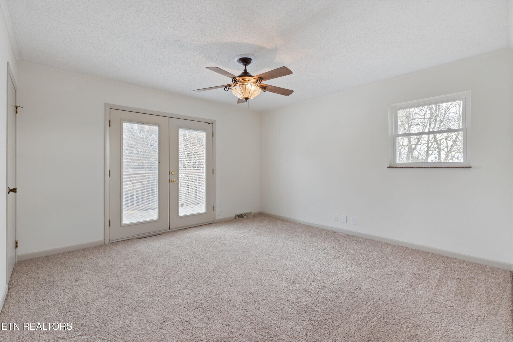 912 Naples Road Knoxville, TN 37923 - Photo 24 of 49 a view of a big room with windows and chandelier fan