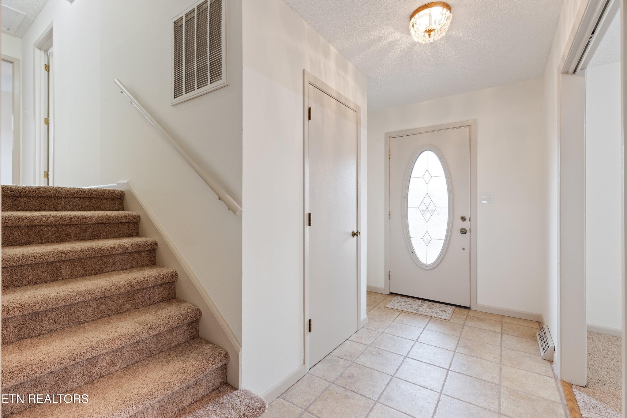 912 Naples Road Knoxville, TN 37923 - Photo 9 of 49 a view of a hallway with entryway wooden floor and front door