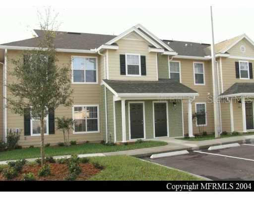 826 Enterprise Road, Unit 4105 DeBary, FL 32713 - Photo 1 of 1 a view of a yard in front of a brick house