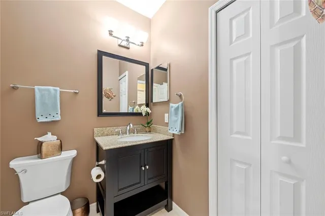 a white toilet sitting next to a bathroom sink