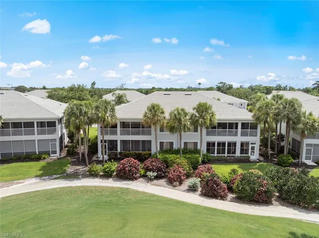an aerial view of a house with a garden and lake view