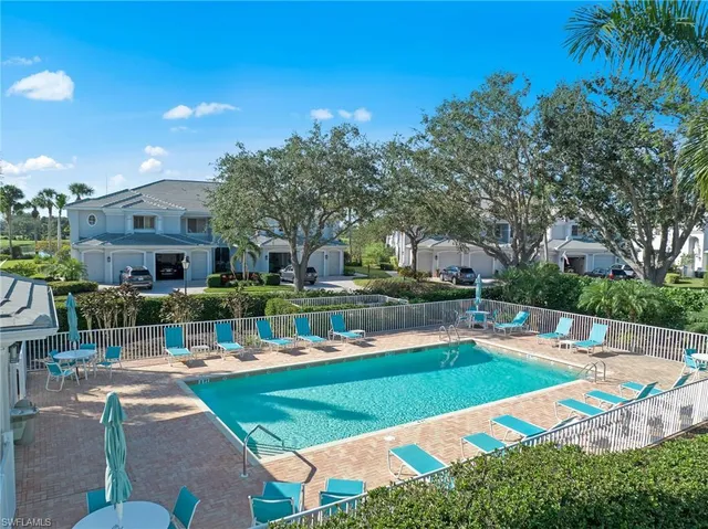a street with trees and houses in the background