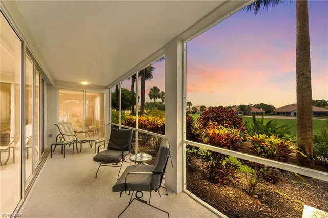 a view of a chair and tables in the balcony