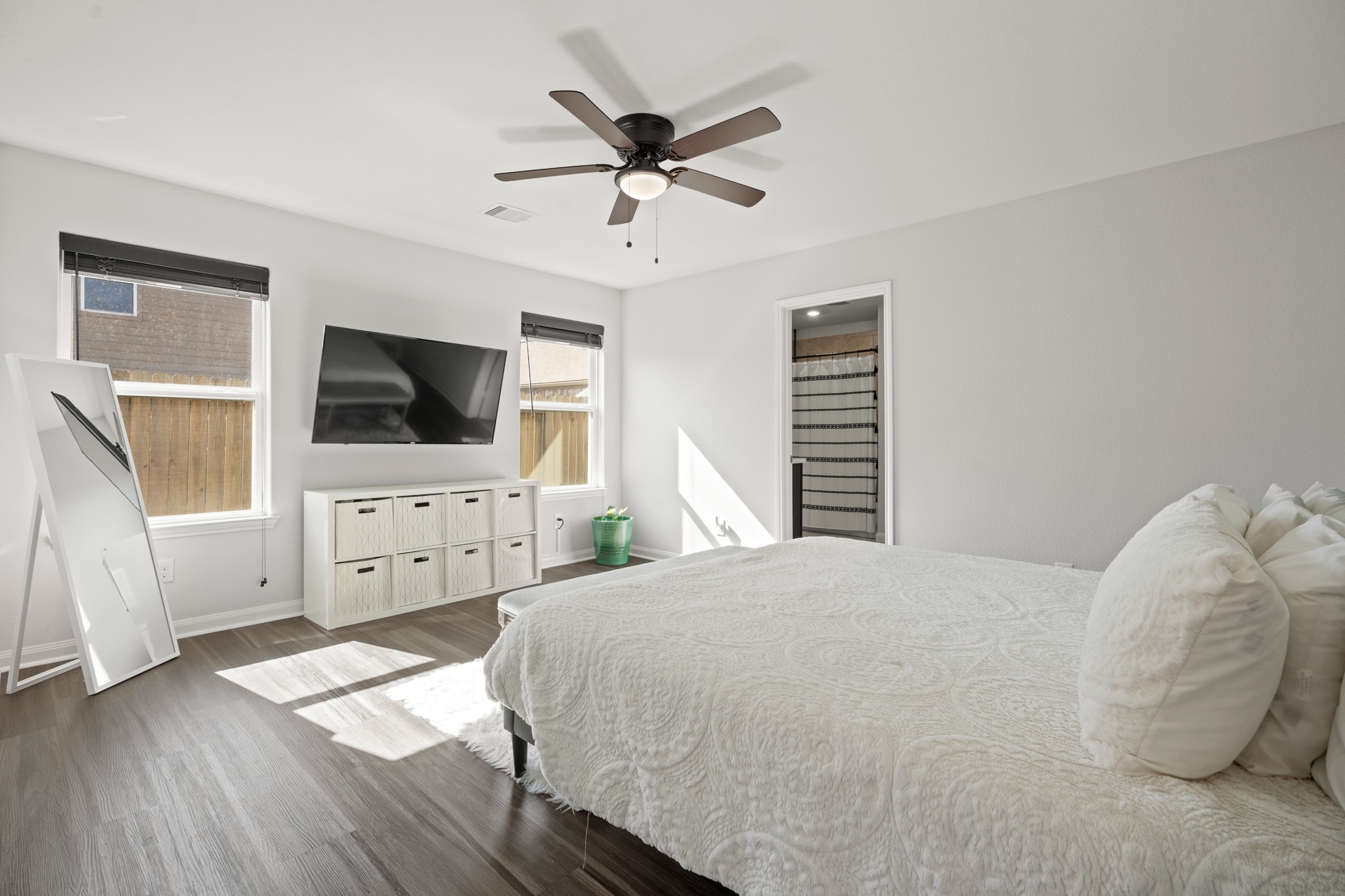 6214 El Topacio Drive Houston, TX 77048 - Photo 17 of 27 a bedroom with a bed and a flat screen tv on dresser