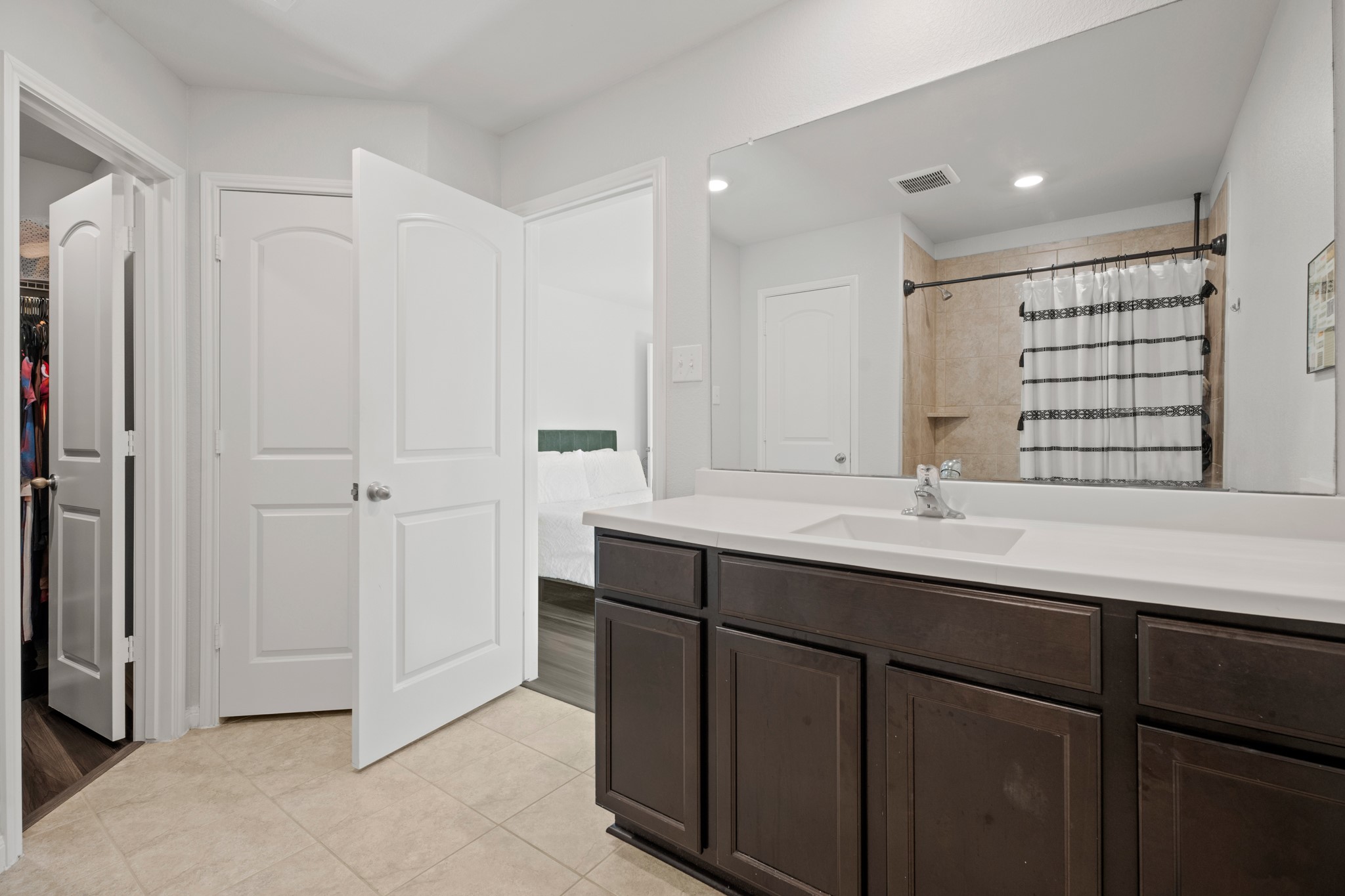 6214 El Topacio Drive Houston, TX 77048 - Photo 20 of 27 a bathroom with a double vanity sink and mirror