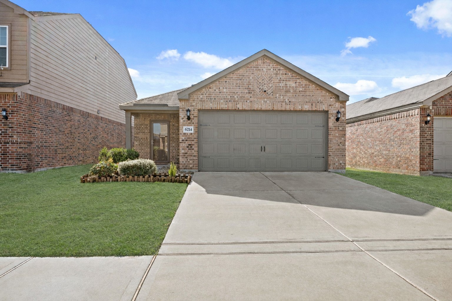 6214 El Topacio Drive Houston, TX 77048 - Photo 2 of 27 a front view of a house with a yard and garage