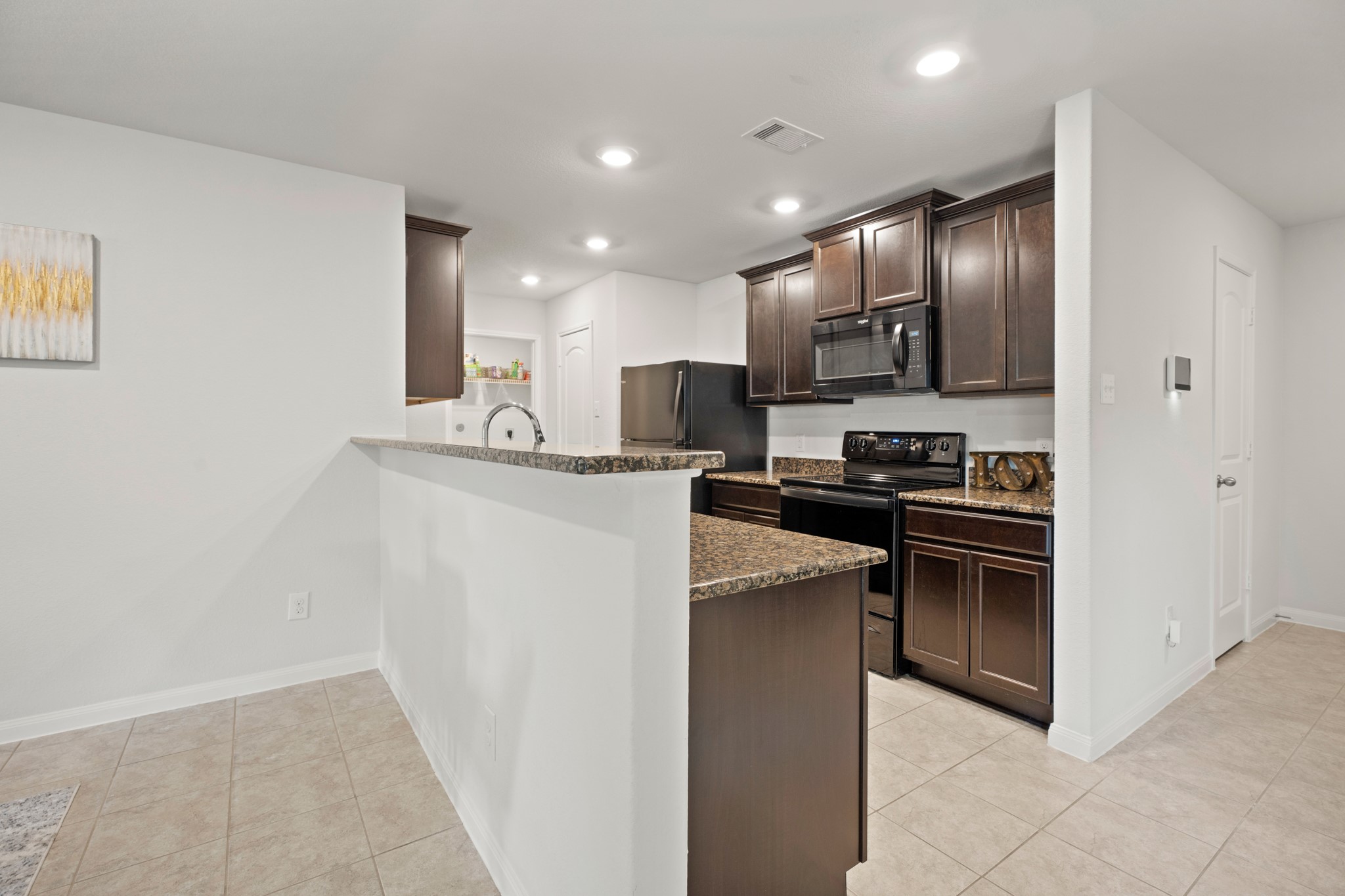 6214 El Topacio Drive Houston, TX 77048 - Photo 7 of 27 a kitchen with stainless steel appliances granite countertop a refrigerator and a stove top oven