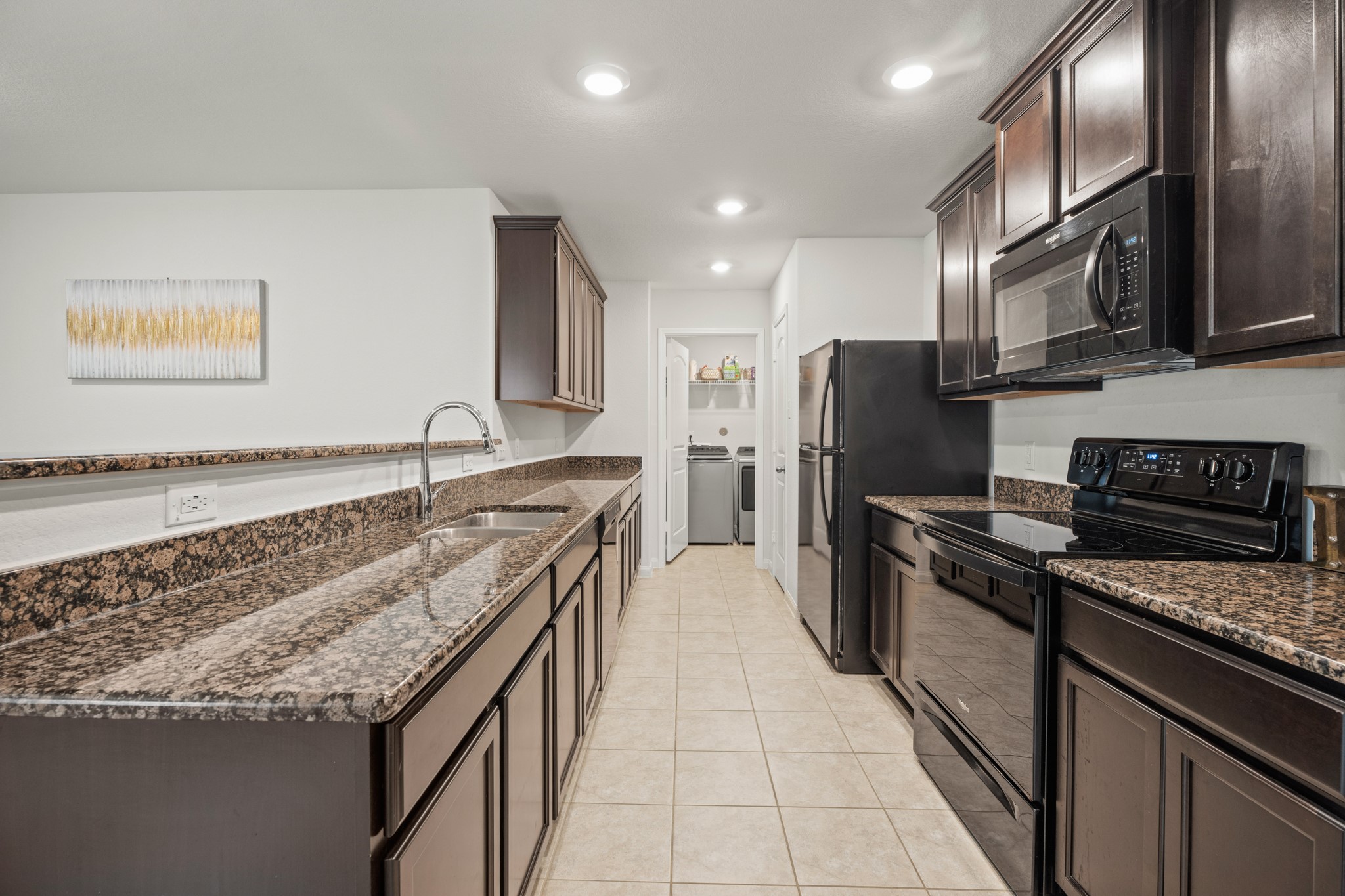 6214 El Topacio Drive Houston, TX 77048 - Photo 8 of 27 a kitchen with stainless steel appliances granite countertop a stove a sink and a refrigerator