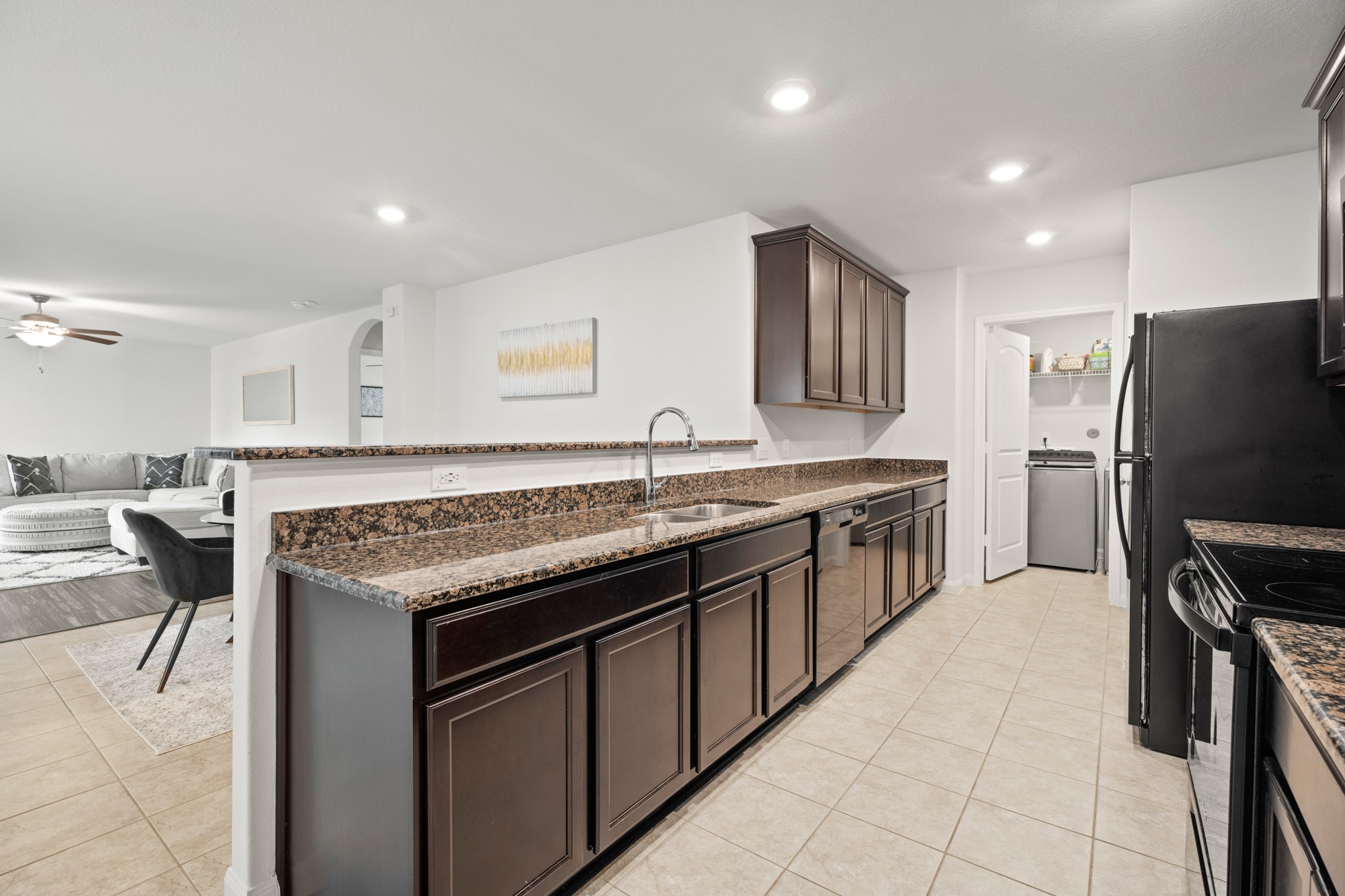 6214 El Topacio Drive Houston, TX 77048 - Photo 9 of 27 a kitchen with stainless steel appliances granite countertop a sink stove and refrigerator