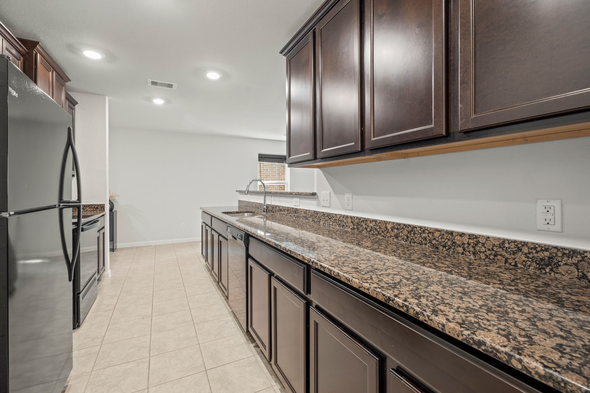 6214 El Topacio Drive Houston, TX 77048 - Photo 10 of 27 a kitchen with granite countertop stainless steel appliances lots of counter top space and cabinets