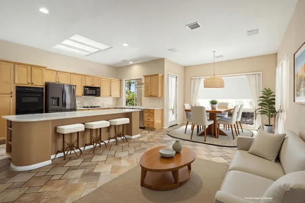 a large kitchen with stainless steel appliances a refrigerator and a stove