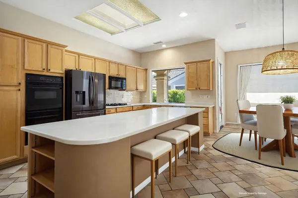 a kitchen with a stove a sink and a refrigerator